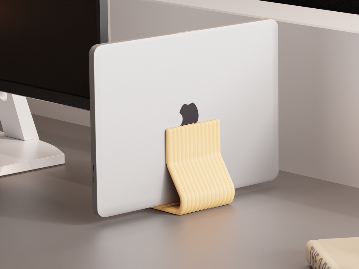 Vertical Laptop Stand. closed lid macbook Stand — Originaldesign im Einsatz, Abstractia Design. Weitere Beispielfarben/Größen; bestellbare Auswahl und Lieferumfang laut Produktseite.